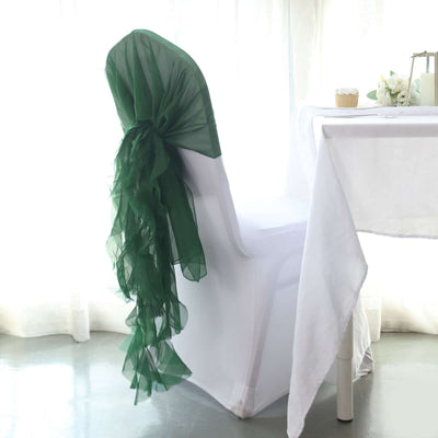 Elegant chair with green organza sash in a bright, airy setting.
