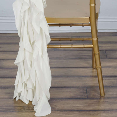 Cream ruffled table runner draped over a gold chair.