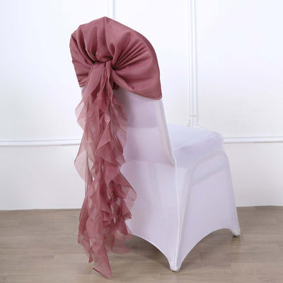 Dusty rose chair sash with ruffled tails on a white chair.