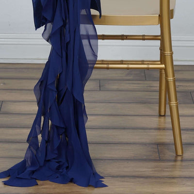 Navy blue chiffon fabric draped elegantly over a gold chair