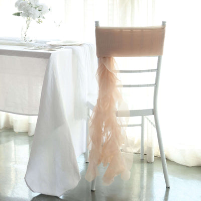 Elegant chair with soft peach ribbon drape, styled for a sophisticated event.