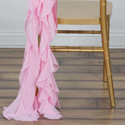 Pink ruffled fabric draped elegantly over a gold chair leg.