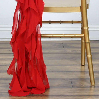 Red ruffled fabric draped over a gold chair leg.