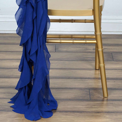 Navy blue chiffon fabric draping elegantly from a gold chair leg.