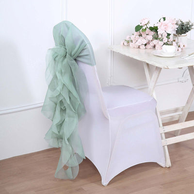 Mint green organza chair sash draped elegantly on a white chair.
