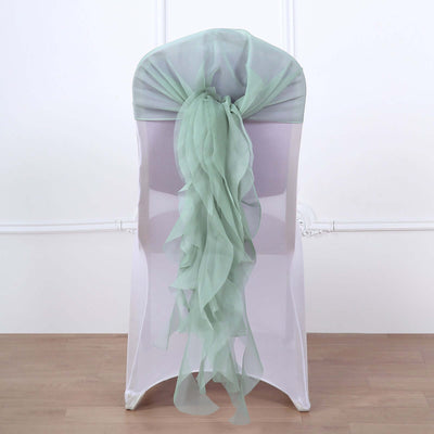 Mint green chair sash with ruffled design on a white chair.