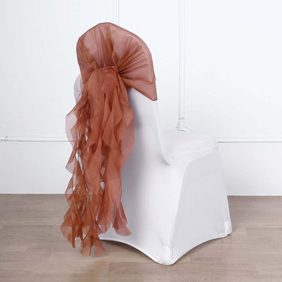 Brown sheer chair sash draped elegantly over a white chair.