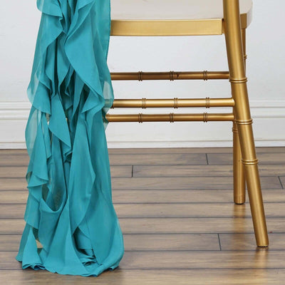 Teal ruffled fabric draped over a gold chair leg.
