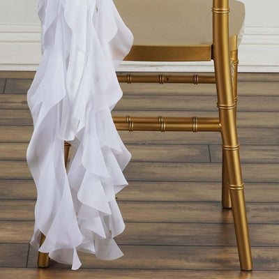 White ruffled fabric draped over a gold chair leg.