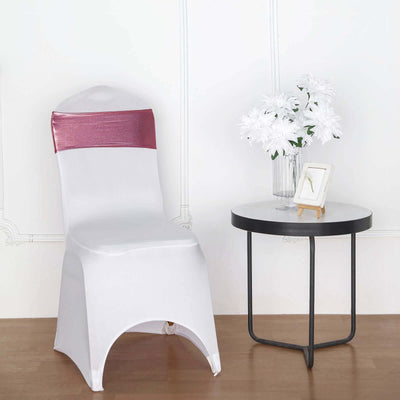 White chair cover with pink sash, styled in a minimalistic setting.