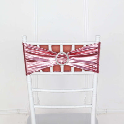 Pink satin chair sash with rhinestone buckle on a white chair