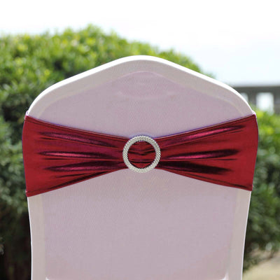 Red satin chair sash with rhinestone buckle for elegant decor.