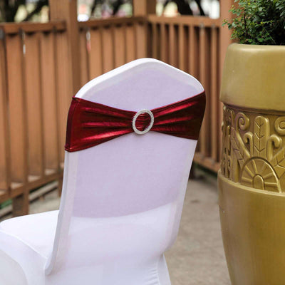 Red satin chair sash with rhinestone buckle for event decor.