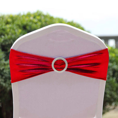 Red satin chair sash with rhinestone buckle, elegantly draped on a white chair.