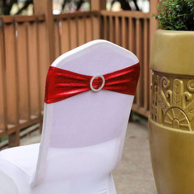 Red satin chair sash with rhinestone buckle on a white chair.