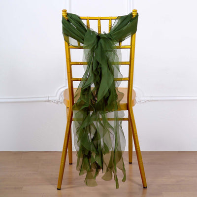 Green chiffon chair sash draped on a gold chiavari chair.