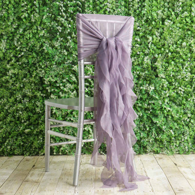Lavender chair sash draped elegantly on a silver chair against greenery backdrop.