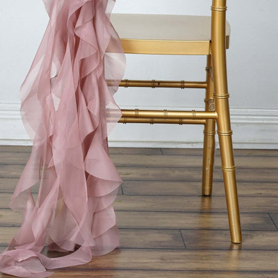 Gold bamboo chair with flowing pink chiffon fabric draped over it.