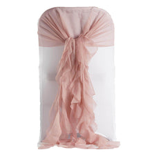 A dusty rose chiffon curly sash on a white chair