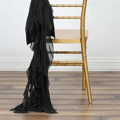 Black ruffled fabric draped over a gold chair in a modern setting.