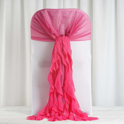 Pink chiffon chair cover with ruffled drapes for events and celebrations.