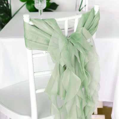 Light green chiffon chair sash draped elegantly over a white chair.