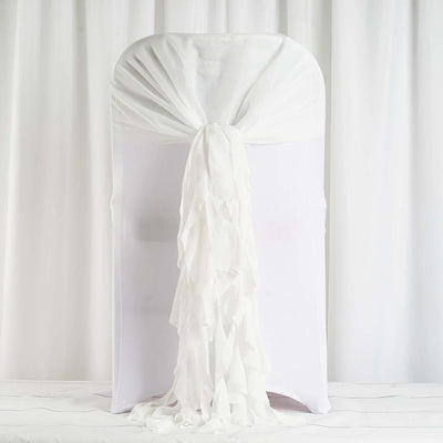 White chair cover with flowing ruffles and draped back.