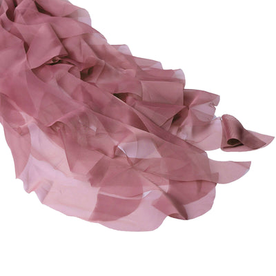 Sheer mauve chiffon fabric draped elegantly on a white background.