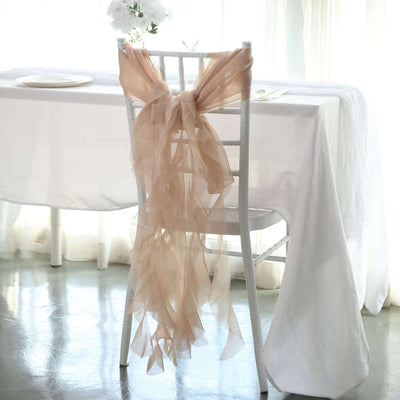 Elegant peach chair sash draped on a white chair at a beautifully set table.