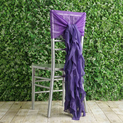 Purple chair sash draped on a silver chair against a green backdrop.