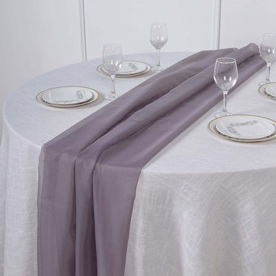 Elegant purple table runner on a white table setting with glassware.