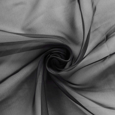 Black sheer fabric swirling in a spiral pattern.