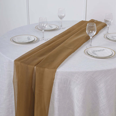 Brown table runner on a dining table set with plates and glasses.