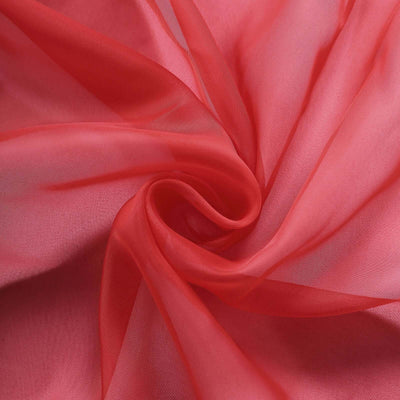 Sheer coral fabric draped in soft folds.