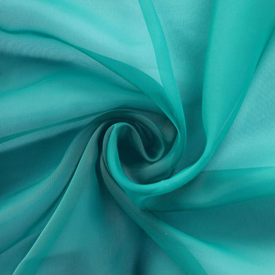 Turquoise sheer fabric in a swirling pattern.