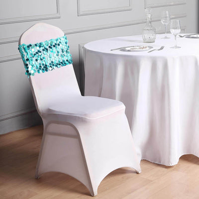 Elegant white chair with turquoise sequin decoration beside a dining table.