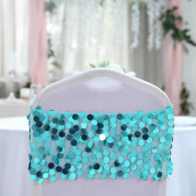 Turquoise sequin chair cover on a white chair in a decorated event space.