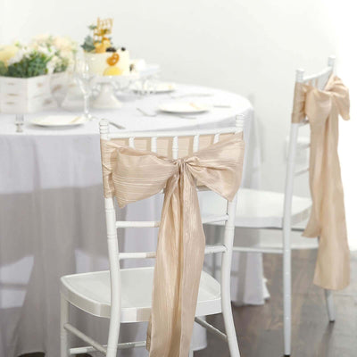 Elegant champagne chair sashes for wedding decor, enhancing table settings.