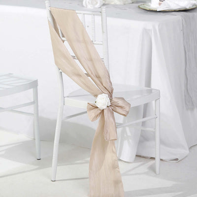 Beige chair sash with rose, elegantly tied on a white chair.