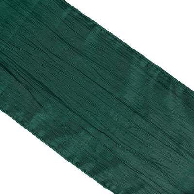 Green textured fabric ribbon on a plain white background