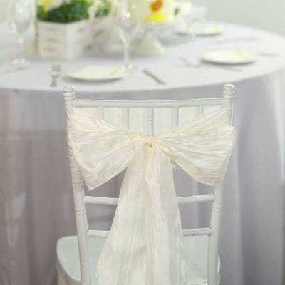 White satin bow on a chiavari chair at an elegant table setting.