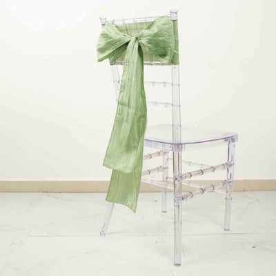 Clear chiavari chair with a light green satin bow