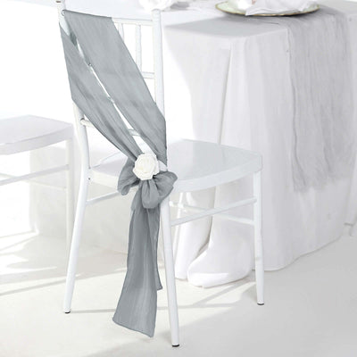 Grey chair sash with rose detail, elegantly draped on a white chair.