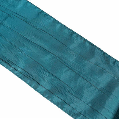 Teal pleated satin ribbon on a white background