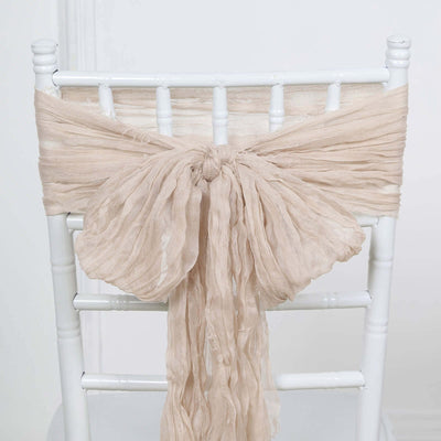 Beige chair sash draped elegantly on a white chiavari chair.