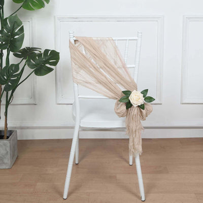 Elegant beige draping on a chair with a decorative rose accent.