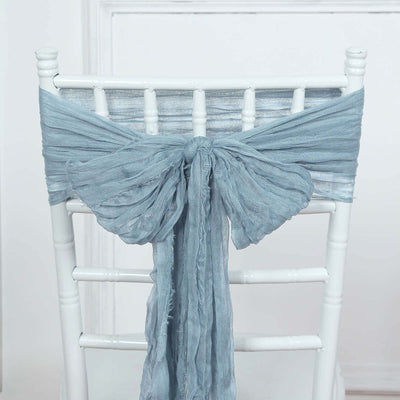 Blue linen chair sash tied in a bow on a white chiavari chair.