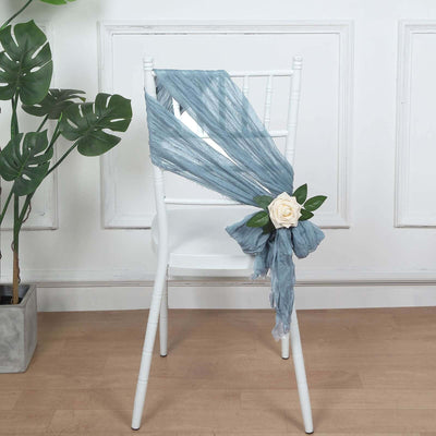 Decorative chair with blue fabric drape and a white rose accent.