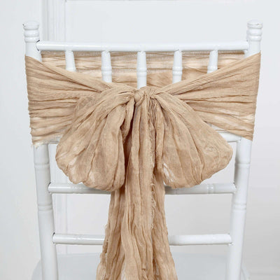 Natural linen chair sash tied in a bow on a white chair.