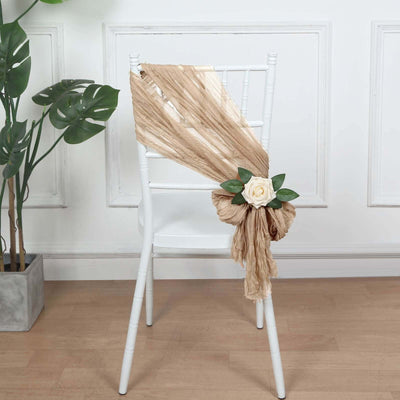 Decorative chair sash with rose and greenery on a white chair